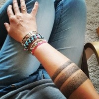 Typical black ink dotwork style arm tattoo of lines