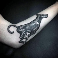 Typical black ink forearm tattoo of running dog skeleton