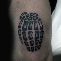 Typical black ink knee tattoo of skeleton hand