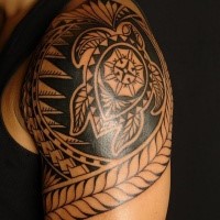 Typical black ink shoulder tattoo of Polynesian ornament with turtle