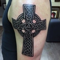 Typical black ink shoulder tattoo of Celtic cross