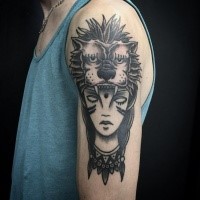 Typical black ink shoulder tattoo of woman face with lion skin helemet