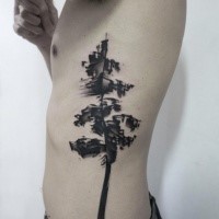 Typical black ink side tattoo of big tree