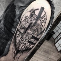 Typical black ink upper arm tattoo of engraving style human heart