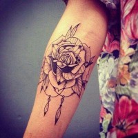 Typical black ink vintage style forearm tattoo of rose flower