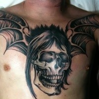 Typical colored chest tattoo of demonic skull with demonic wings