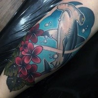 Typical colored leg tattoo of hammerhead shark and flowers