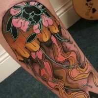 Typical colored leg tattoo of jellyfish stylized with flowers