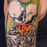 Typical colored shoulder tattoo of kissing skeleton couple