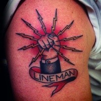 Typical colored shoulder tattoo of lineman symbol with lettering