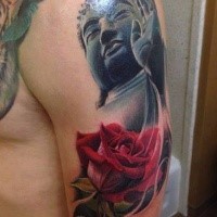 Typical designed and colored shoulder tattoo of stone Buddha statue and rose flower
