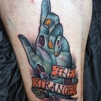 Typical designed and colored zombie hand tattoo stylized with lettering