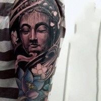 Typical designed colored sleeve tattoo of Buddha statue with flowers