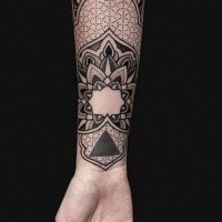 Typical dotwork style forearm tattoo of floral ornament
