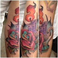 Typical illustrative style colored burning candle tattoo with rose