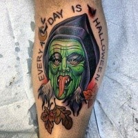 Typical illustrative style colored leg tattoo of creepy witch with lettering and leaves