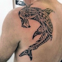 Typical large black ink back tattoo of Polynesian style shark