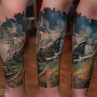 Typical multicolored arm tattoo of sailing ship with big waves