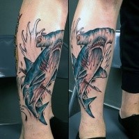 Typical new school style colored leg tattoo of harpooned hammerhead shark and waves