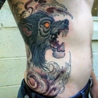 Typical old school style colored evil werewolf head tattoo on side