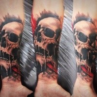 Typical realistic looking colored forearm tattoo of human skull