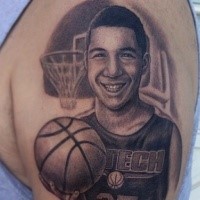 Typical realistic looking shoulder tattoo of young basketball player