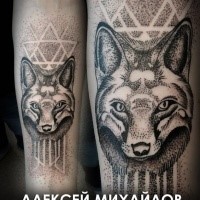 Typical stippling style forearm tattoo of wolf with geometrical ornaments