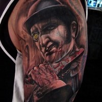 Unbelievable big detailed looking shoulder tattoo of terrifying maniac with bloody knife
