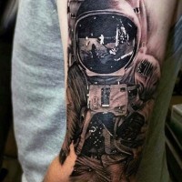 Unbelievable black and white detailed spaceman on moon arm tattoo