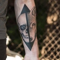 Unbelievable black ink forearm tattoo of split wolf and human skull by Valentine Hirsch