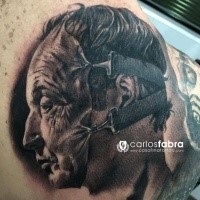 Unbelievable black ink tattoo of man with human skin mask