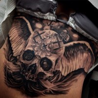 Unbelievable mysterious human skull with wings tattoo combined with tiny butterfly