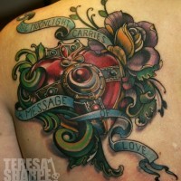 Unbelievable painted colored mechanical heart tattoo on back with flowers and lettering