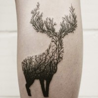 Unique black ink deer shaped tattoo stylized with forest trees