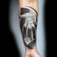 Unique designed and colored hand with clock tattoo on arm