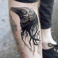 Unique painted little black ink crow head tattoo on leg