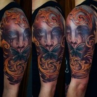 Illustrative style colored shoulder tattoo of crying woman with butterflies