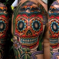 Illustrative style colored shoulder tattoo of Mexican skull and cactus