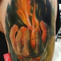Illustrative style colored shoulder tattoo of man with burning hand