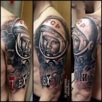 New school style colored shoulder tattoo of famous astronaut with lettering