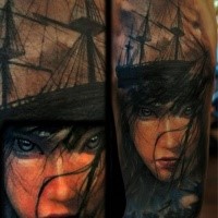 Illustrative style colored shoulder tattoo of woman face with ship