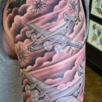 Illustrative style colored shoulder tattoo of large American bomber planes