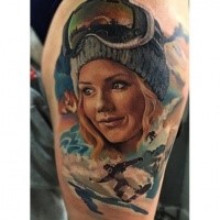Illustrative style colored shoulder tattoo of cute woman with snowboarder