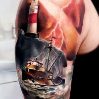 Illustrative style colored shoulder tattoo of sailing ship with lighthouse