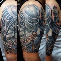 Illustrative style colored shoulder tattoo of Predator with human skulls