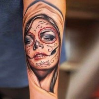 New school style colored forearm tattoo of Mexican traditional face