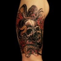 New school style colored shoulder tattoo of human skull with snake