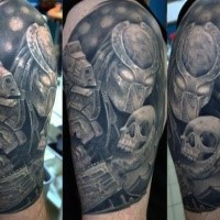 Illustrative style colored shoulder tattoo of Predator with human skull