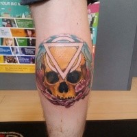 New school style colored leg tattoo of human skull with mystical symbol