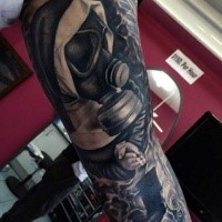 Unusual black and white sleeve tattoo of praying mother with gas mask